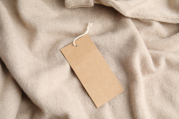 Warm beige cashmere sweater with tag, closeup