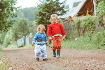 Fototapeta premium sister and brother walking down the street