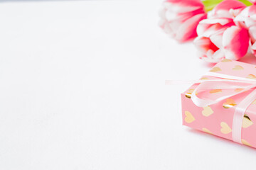 Valentines day composition with pink tulips and gift box on a white background