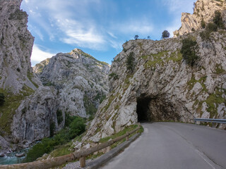 Tunnel entrance Cares at the Route in the heart of Picos de Europa National Park, Spain. Narrow and impressive canyon between cliffs, bridges, caves, footpaths and rocky mountains.