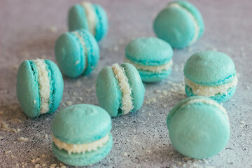 Macaroons. Delicious French desserts. Macaroons with coconut flakes. Blue macaroons on the table