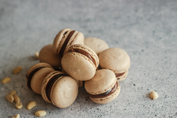 Macaroons. Delicious French desserts. Macaroons with chocolate ganache. Brown macaroons on the table