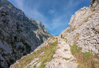 The Cares Route in the heart of Picos de Europa National Park, Cain-Poncebos, Asturias, Spain. Narrow and impressive canyon between cliffs, bridges, caves, footpaths and rocky mountains.