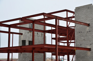 Concrete and steel frame multi story bank building under construction in urban area.