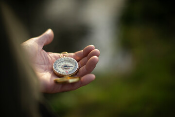 Close up man holding compass