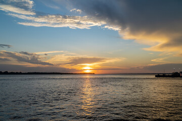 Beautiful sunset view on the Amazon River and colorful clouds. Amazonas, Brazil. Concept of environment, ecology, nature, conservation, travel destination, idyllic landscape, climate change.