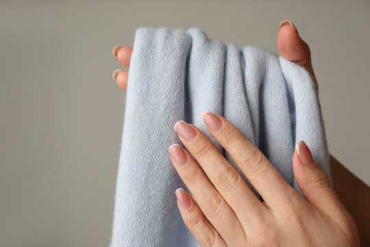 Woman With Cashmere Sweater On Beige Background, Closeup