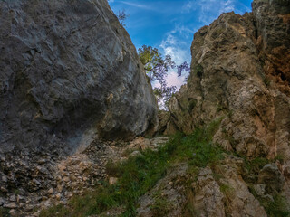 The Cares Route in the heart of Picos de Europa National Park, Cain-Poncebos, Asturias, Spain. Narrow and impressive canyon between cliffs, bridges, caves, footpaths and rocky mountains.