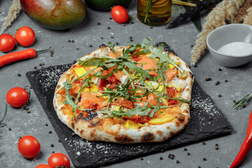 Delicious pizza with salmon and vegetables. italian pizza