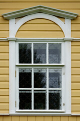 Window on a yellow wall.