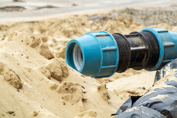 Close up of coupling for HDPE pipes on the sand during the repair work of the pipeline on the...