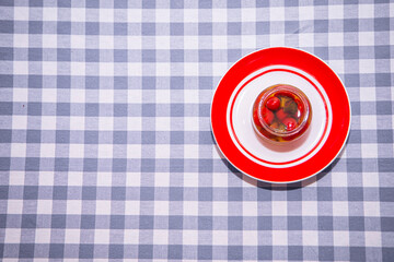 red and white plate, food on a red plate on a blue cloth, tablecloth in a cage, food close-up, healthy eating, geometric patterns, dishes with red and white circles, space for text, copy space