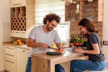 Couple cooking together in the kitchen