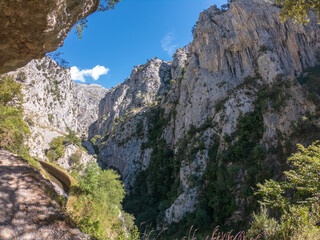 The Cares Route in the heart of Picos de Europa National Park, Cain-Poncebos, Asturias, Spain. Narrow and impressive canyon between cliffs, bridges, caves, footpaths and rocky mountains.
