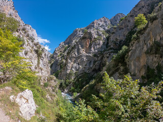 The Cares Route in the heart of Picos de Europa National Park, Cain-Poncebos, Asturias, Spain. Narrow and impressive canyon between cliffs, bridges, caves, footpaths and rocky mountains.