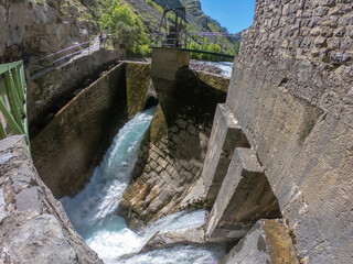 Fototapeta na wymiar The Caín Hydro-electric dam on the River Cares. The Cares Route, placed in the very heart of Picos de Europa National Park, also known as “La Garganta Divina” (The Divine Gorge).