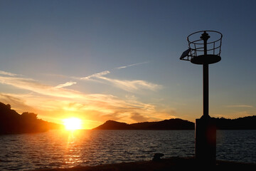 Small lighthouse and beautiful sunset on island Lastovo, Croatia.
