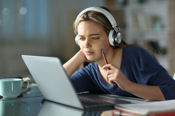 Pensive student e-learning using laptop in the night