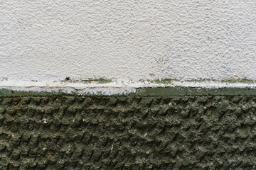 Aged dark green termal isolation wall texture grain rough surface compared to new white clean high quality construction in Sofia, Bulgaria, Eastern Europe
