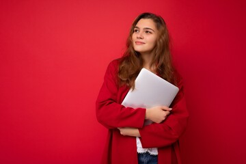 Side profile portrait shot of mysterious Beautiful young dark hair curly woman holding close laptop...