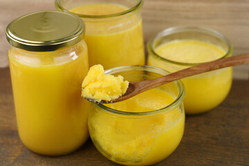 Homemade ghee (Sade yag) in jars and wooden spoon . Ghee is purified butter.   
