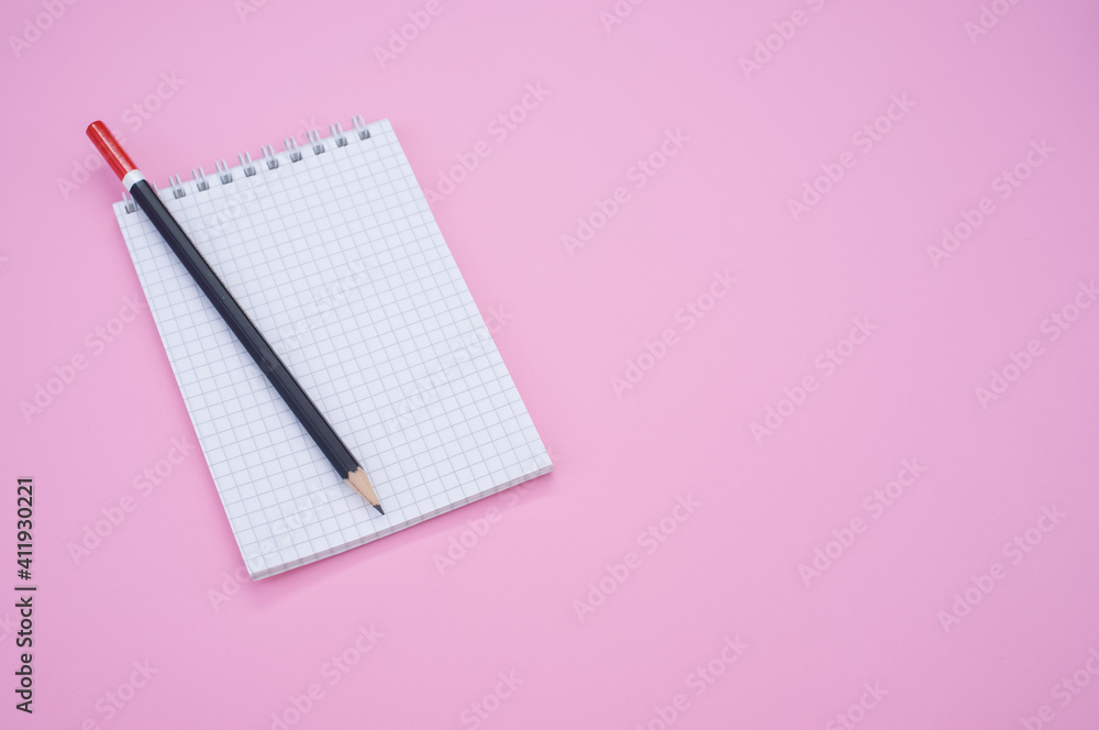 Aufkleber overhead shot of a pencil on a grid notepad isolated on pink background with space for your text
