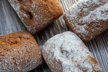 Close-up muffins with bran with raisins. Healthy or not healthy food concept. Cupcakes, muffins in powdered sugar close-up.