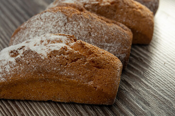 Close-up muffins with bran with raisins. Healthy or not healthy food concept. Cupcakes, muffins in powdered sugar close-up.