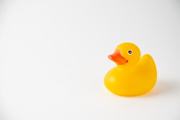 View of a yellow duckling for children's bath, on white background, horizontal, with copy space