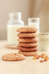 Homemade raisin oatmeal cookies raisins, cup of coffee or tea and milk on the table. Healthy Food Snack Concept. Selective focus, copy space