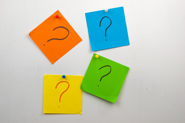 many colorful memo sheets on the wall with question mark