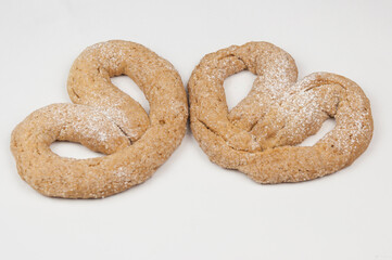 a pair of appetizing pretzels on white background