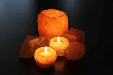 Himalayan salt candles holders on the dark desk