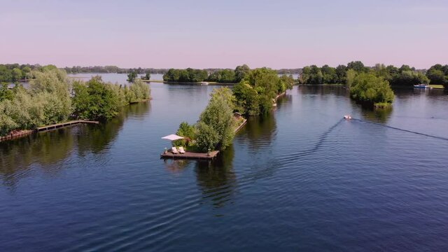 Typical landscape in the Netherlands. Artificial Dutch private islands on big blue lake. Many tourist travel here to drive a boat and enjoy the calm and quiet nature. Vinkeveen, Utrecht 11