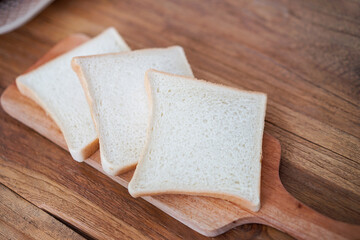 Slices of toast bread on a wooden cutting board for sandwich