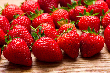 Fresh pleasant strawberries on a wooden table. Strawberry juice