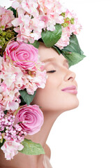 Fashion Beauty Model Girl with flowers in the hair. Bouquet of Beautiful Flowers. Perfect skin.  fashion model with large hairstyle and flowers in her hair.