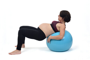 Fototapeta premium pregnant woman exercising with a ball on white background