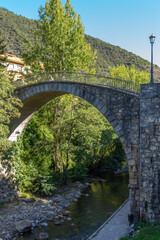 Old ancient bridge over the Deva River in the Village of Potes in the Shire of Liebana, Picos de Europa, Cantabria, Spain.