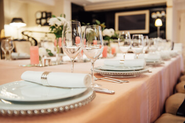 Luxurious restaurant. Luxurious interior, white tables, serving dishes and glasses for guests