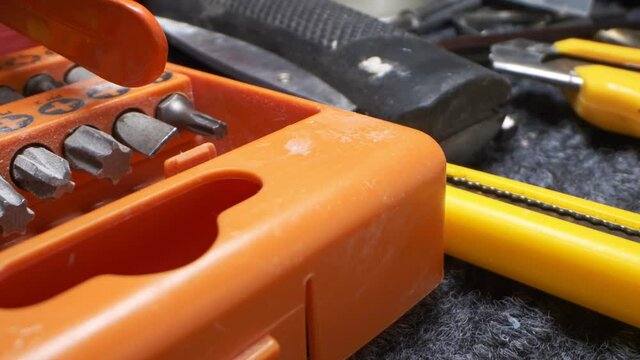 extremely close-up, detailed. drill bits in orange toolbox.