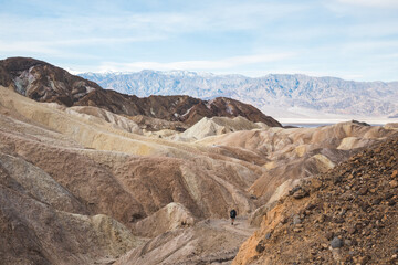 Hiker on trail at Zabriskie Point in Death Valley, California