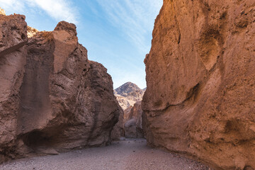 colorful desert canyon reveals a distant mountain in Death Valley, California