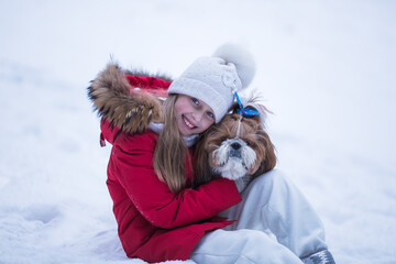 Winter portrait of a girl with a Shih Tzu dog.