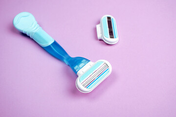 Women razor with replaceable cartridge isolated on a pink background. Close-up. Beauty concept.