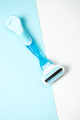 Women razor isolated on a blue background. Close-up. Beauty concept.