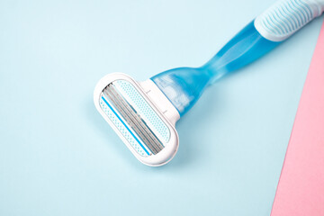 Women razor isolated on a blue background. Close-up. Beauty concept.