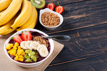 .Brazilian açaí in a bowl accompanied by tropical fruits. Fruit of the Amazon