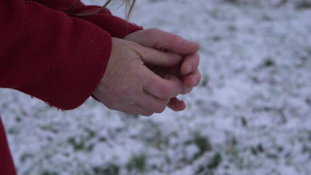 Woman in cold weather rubbing hands to keep warm 