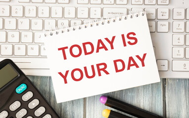 Motivational inscription in notepad TODAY IS YOUR DAY. Notebooks and keyboard.